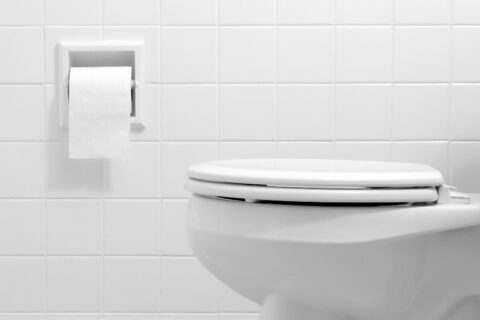 Clean white bathroom toilet with the lid closed